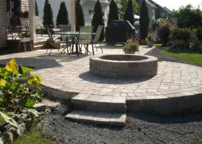 outdoor stone patio with brick fire pit