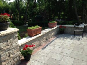 outdoor stone patio with flowers and plants