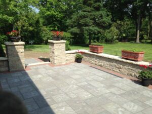 outdoor stone patio with flowers and plants
