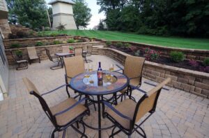 outdoor stone patio with wine glasses on table